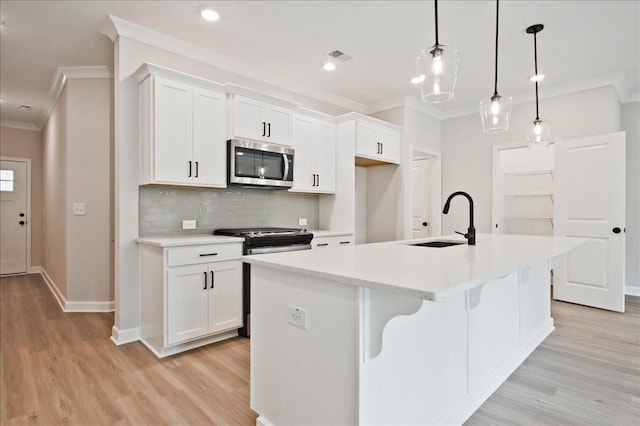 kitchen with a sink, appliances with stainless steel finishes, and ornamental molding