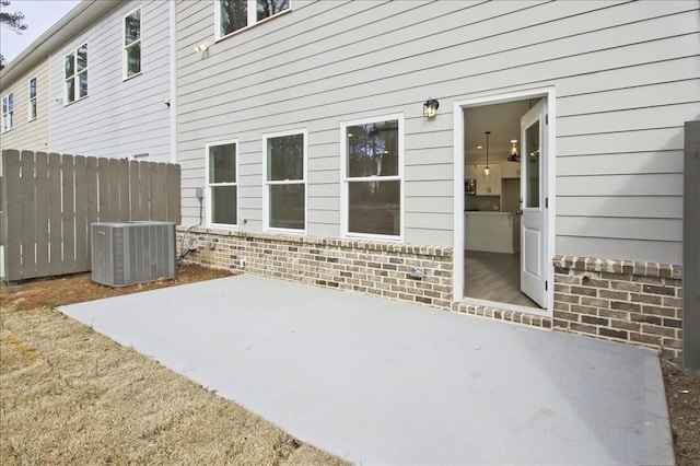 view of patio / terrace with central AC unit and fence