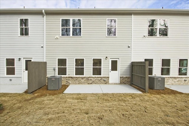 back of house featuring a lawn, a patio, and central AC