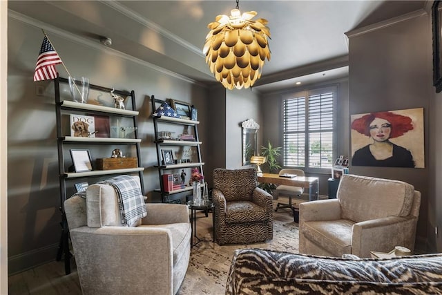 sitting room with crown molding, wood finished floors, a chandelier, and baseboards