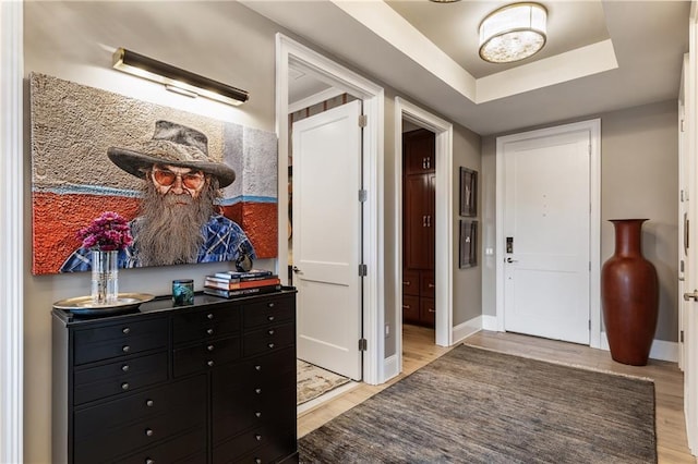 entryway with light wood-style floors and baseboards