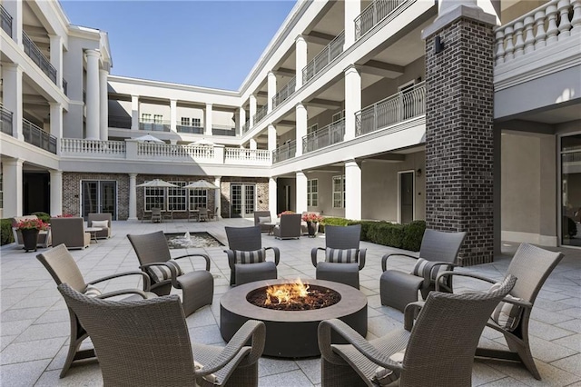 view of patio / terrace with an outdoor living space with a fire pit