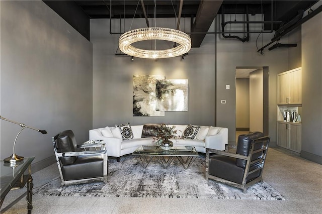 living room featuring a high ceiling and baseboards