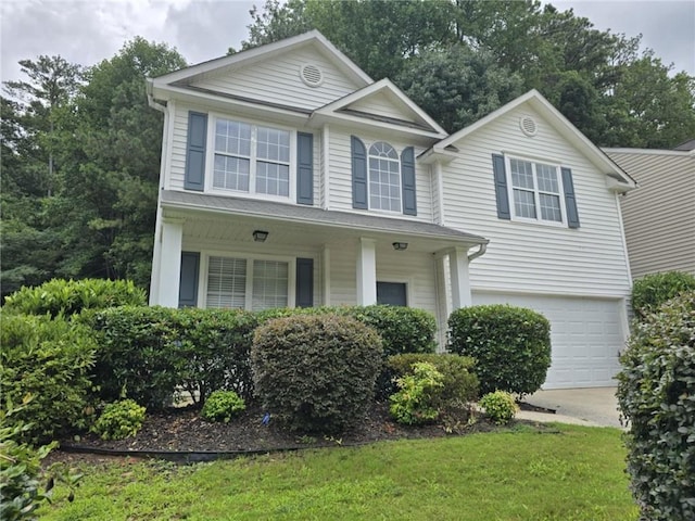 view of front of home with a garage and a front yard