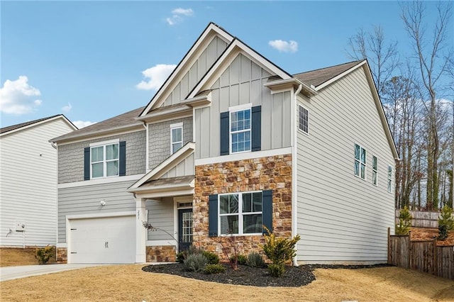 craftsman-style house featuring stone siding, board and batten siding, fence, and driveway