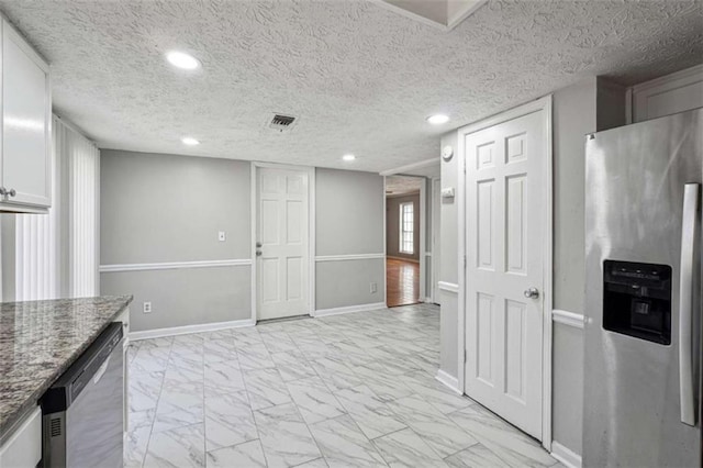 kitchen featuring marble finish floor, appliances with stainless steel finishes, visible vents, and baseboards