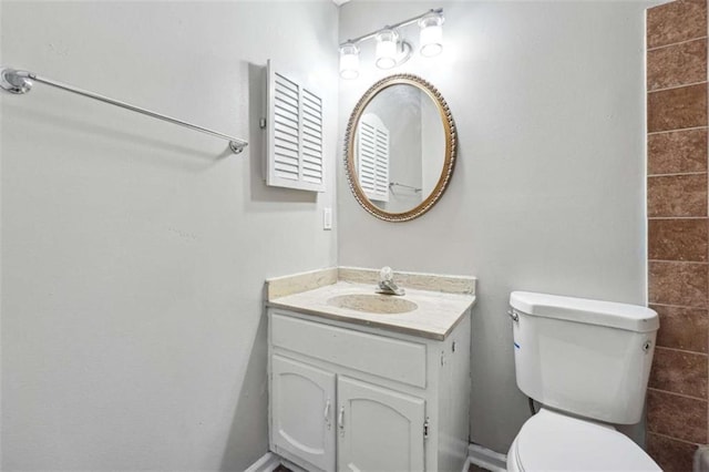 bathroom with toilet and vanity