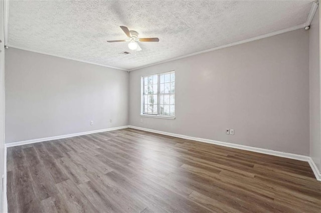 unfurnished room with ornamental molding, wood finished floors, a ceiling fan, and baseboards