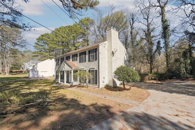 exterior space with driveway and a chimney