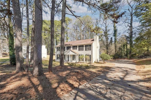 colonial home featuring a chimney