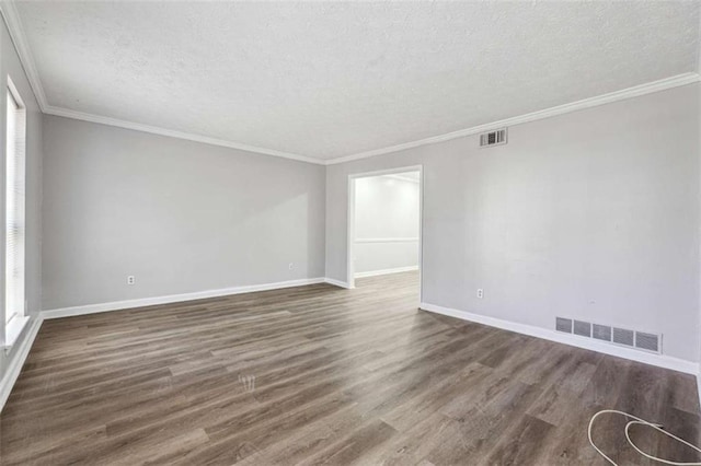 unfurnished room with a textured ceiling, dark wood-type flooring, visible vents, and baseboards