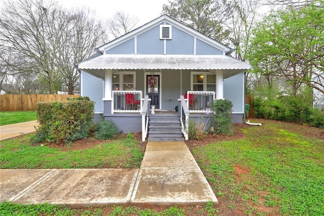 bungalow-style house with a front yard and a porch