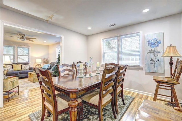 dining space with light hardwood / wood-style floors and ceiling fan