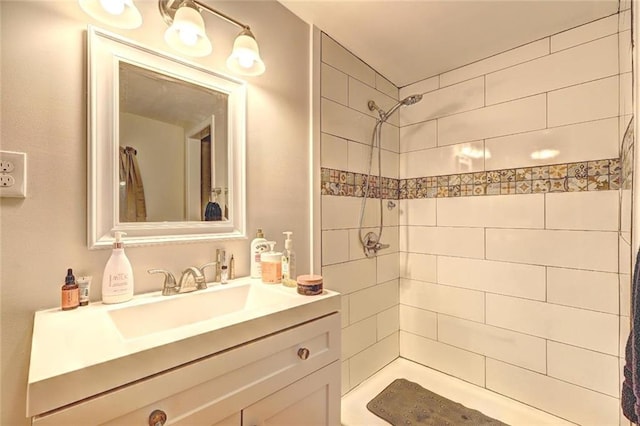 bathroom with vanity and tiled shower