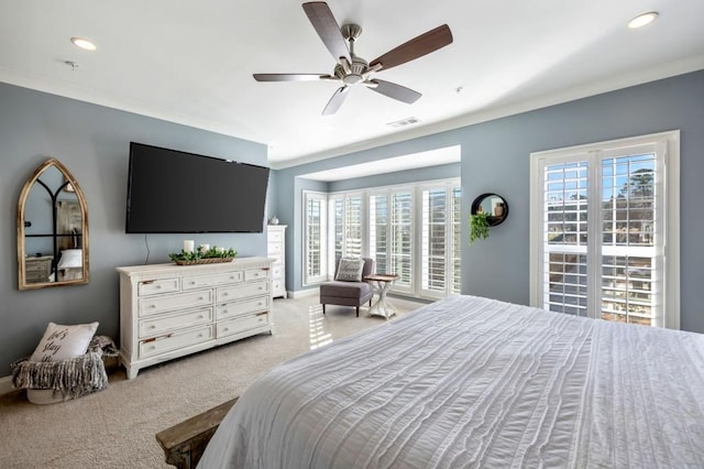 bedroom featuring multiple windows, light colored carpet, and ceiling fan