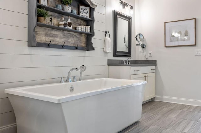 bathroom featuring vanity and a tub