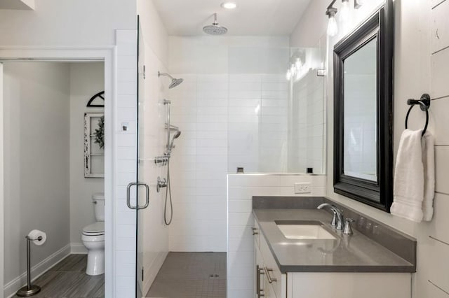 bathroom with vanity, an enclosed shower, and toilet