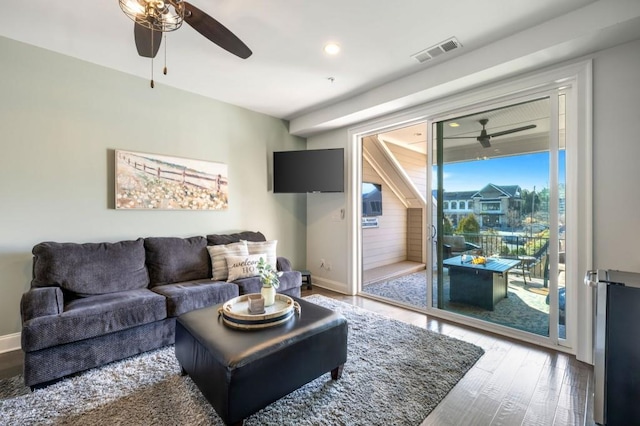 living room featuring hardwood / wood-style floors and ceiling fan