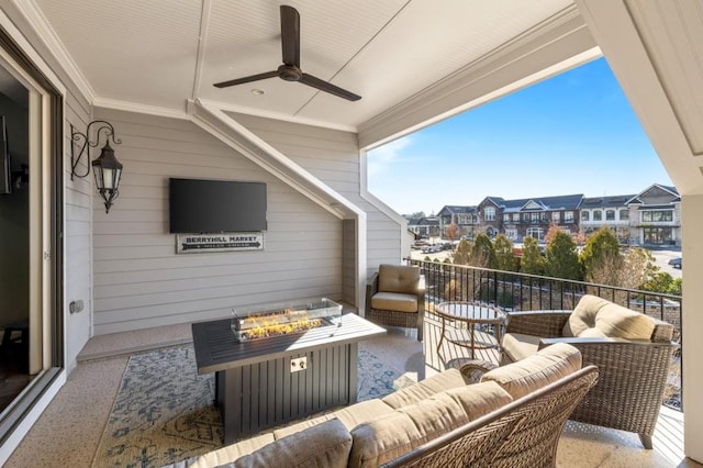 balcony featuring an outdoor living space with a fire pit and ceiling fan