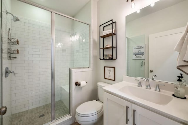 bathroom with walk in shower, vanity, and toilet