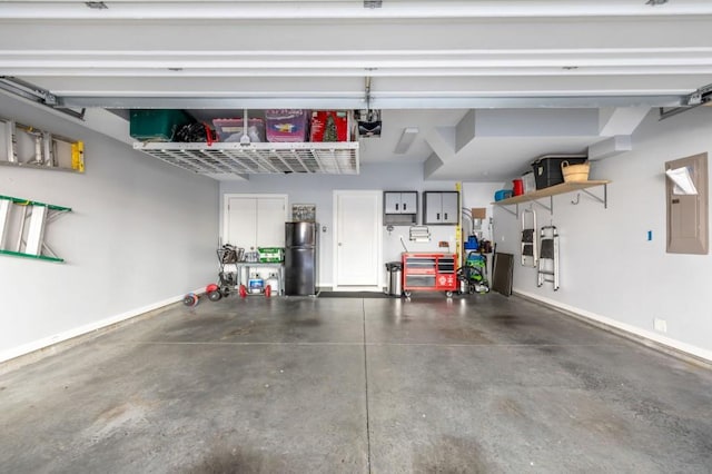 garage with electric panel and refrigerator