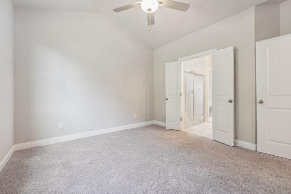 bathroom featuring vanity, an enclosed shower, and ceiling fan