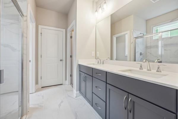 bathroom featuring vanity and an enclosed shower