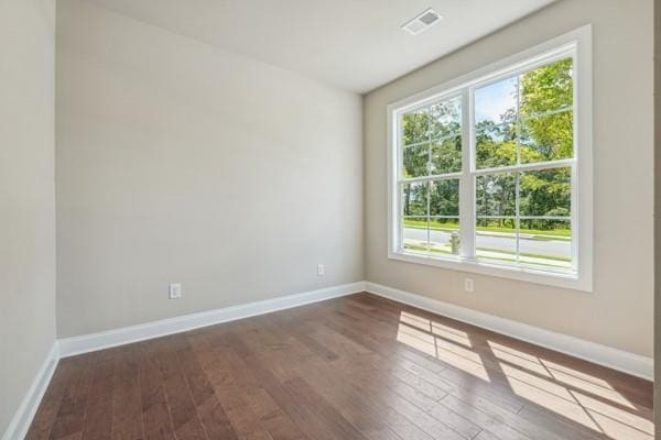 spare room with dark wood-type flooring