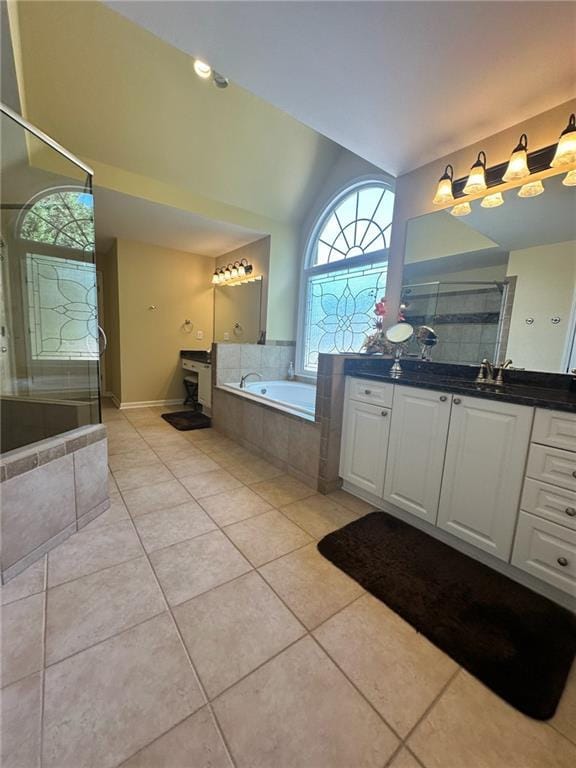 bathroom with tile patterned flooring, vanity, and independent shower and bath