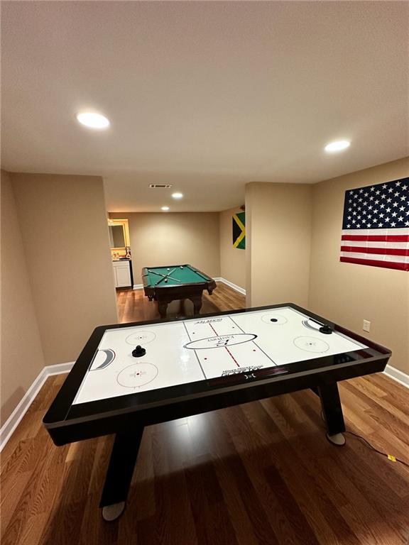 game room with hardwood / wood-style floors and billiards