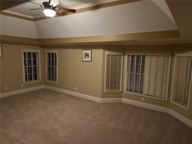 carpeted spare room featuring ceiling fan, a raised ceiling, and ornamental molding