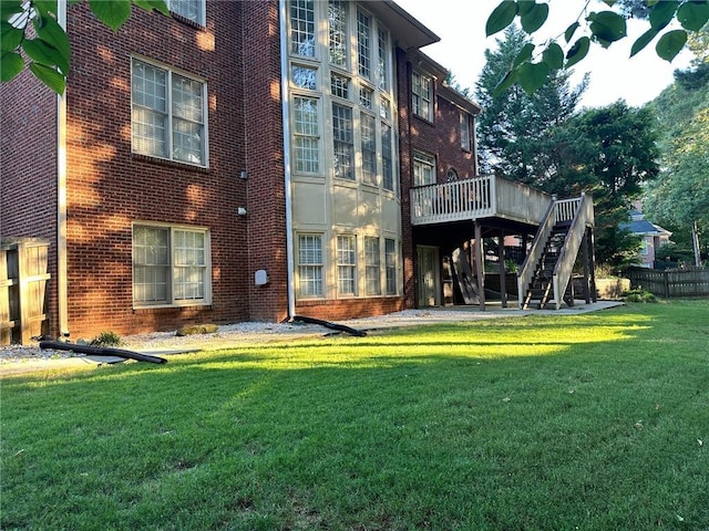 back of house with a lawn and a deck