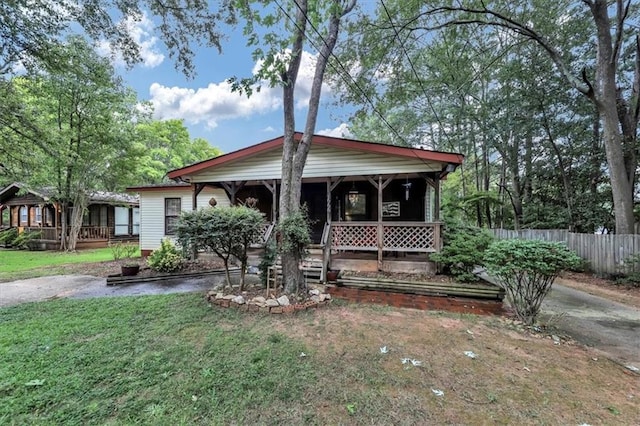 view of front of house with a porch and a front lawn