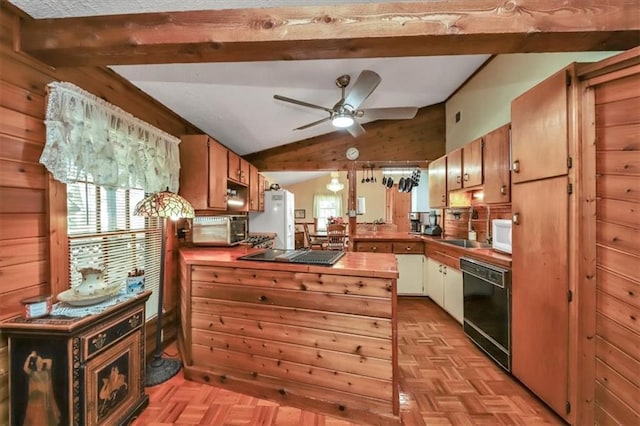 kitchen featuring lofted ceiling with beams, a healthy amount of sunlight, wooden walls, a peninsula, and black appliances