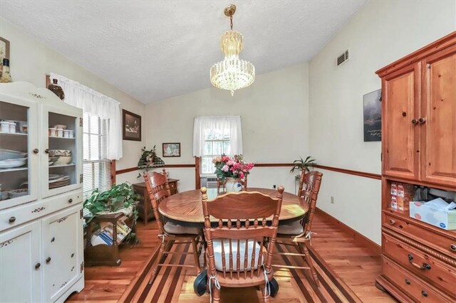 kitchen featuring ceiling fan, light parquet flooring, appliances with stainless steel finishes, and a textured ceiling