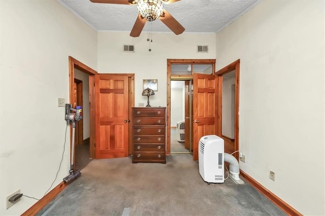 bedroom featuring ornamental molding, visible vents, a textured ceiling, and carpet flooring