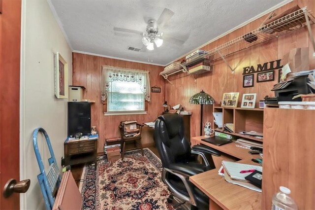 office area with a textured ceiling, a ceiling fan, visible vents, and crown molding