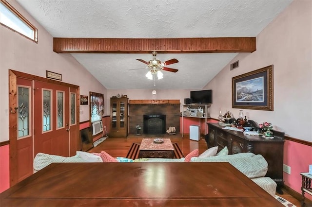 living room with lofted ceiling with beams, hardwood / wood-style flooring, a textured ceiling, and ceiling fan