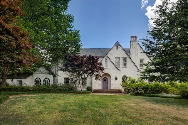 english style home with a front yard