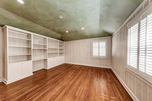 unfurnished room with vaulted ceiling and hardwood / wood-style flooring