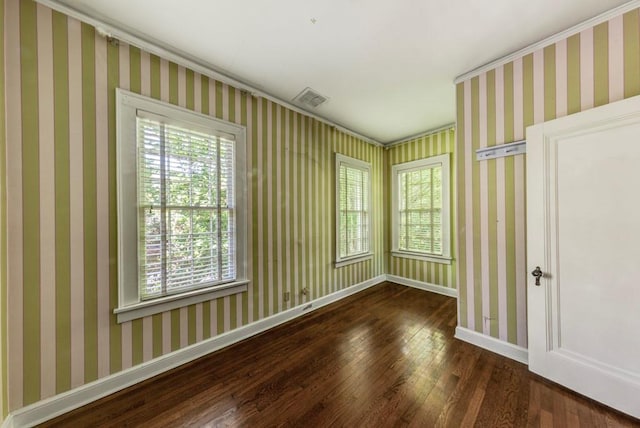 unfurnished room featuring dark hardwood / wood-style floors and crown molding