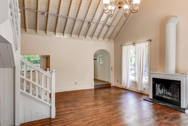 unfurnished living room featuring dark wood-type flooring, wooden ceiling, an inviting chandelier, beamed ceiling, and high vaulted ceiling