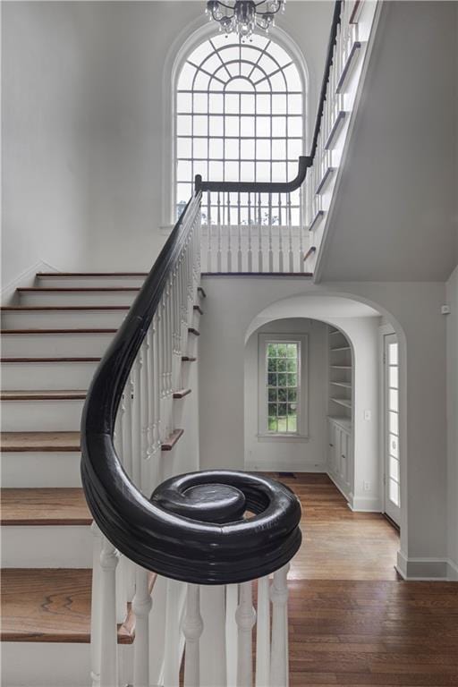 stairway featuring a chandelier and hardwood / wood-style flooring