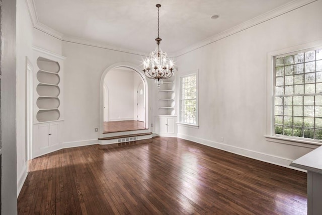 unfurnished dining area with a chandelier, dark hardwood / wood-style floors, built in features, and ornamental molding