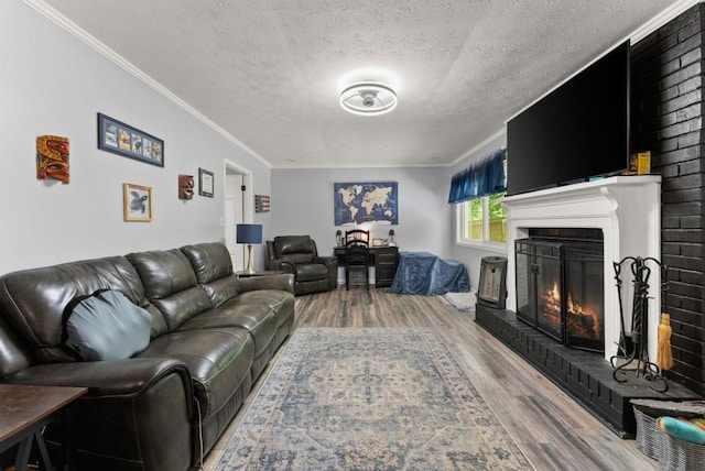 1467 Hewatt Rd, Lilburn, GA 30047 - living room featuring wood finished floors, ornamental molding, a brick fireplace, and a textured ceiling