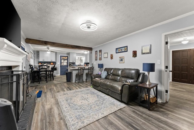 1467 Hewatt Rd, Lilburn, GA 30047 - living area featuring wood finished floors, a textured ceiling, ornamental molding, a ceiling fan, and baseboards