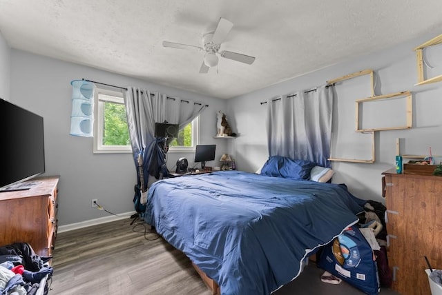 1467 Hewatt Rd, Lilburn, GA 30047 - bedroom featuring wood finished floors, baseboards, a textured ceiling, and ceiling fan