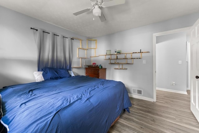 1467 Hewatt Rd, Lilburn, GA 30047 - bedroom featuring baseboards, wood finished floors, and a ceiling fan