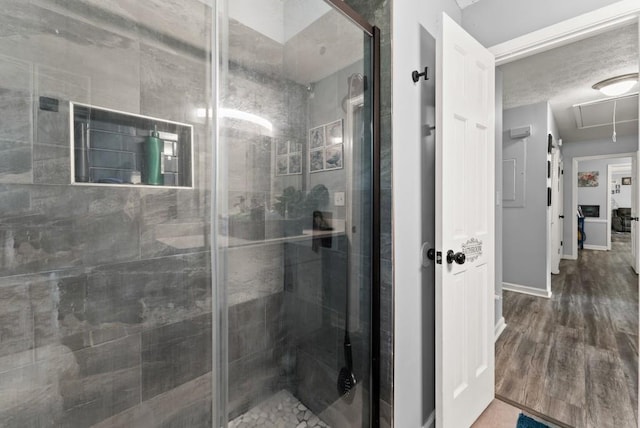 1467 Hewatt Rd, Lilburn, GA 30047 - bathroom with a stall shower, baseboards, and wood finished floors
