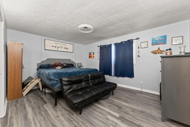 1467 Hewatt Rd, Lilburn, GA 30047 - bedroom featuring wood finished floors, baseboards, and a textured ceiling